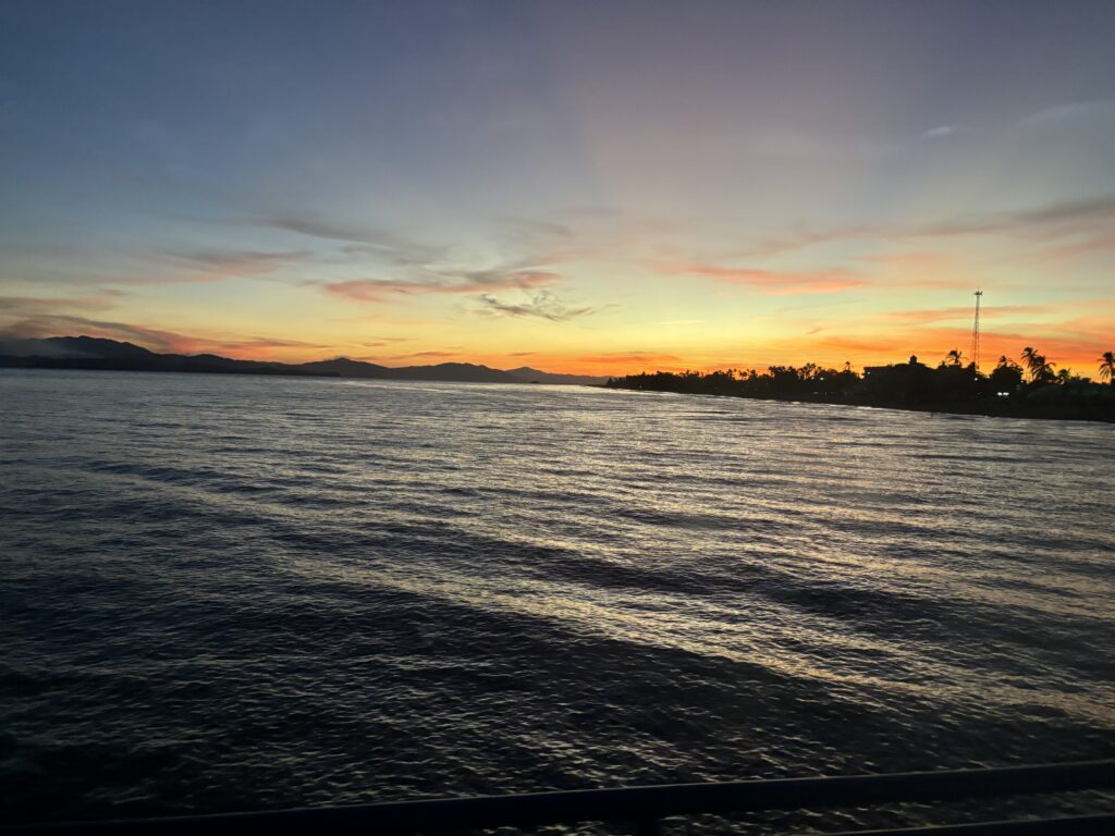 Sunset over open water viewed from a cruise ship