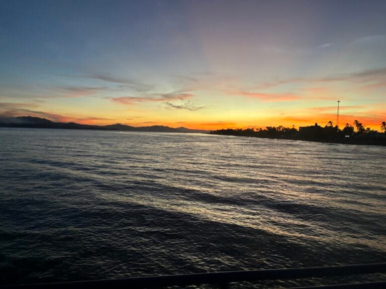 Sunset over open water viewed from a cruise ship
