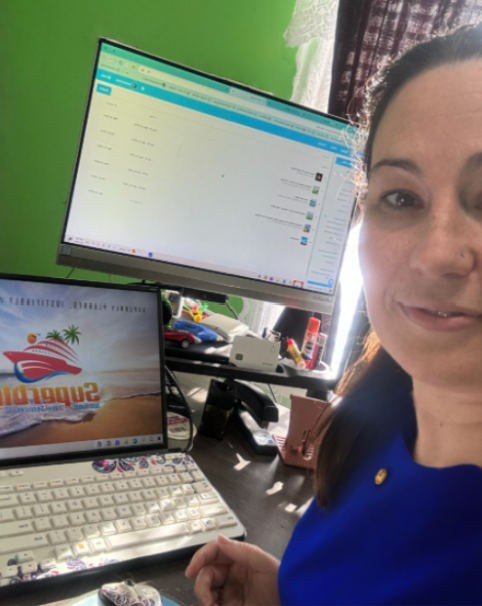 Jessica Gray, certified travel advisor, working at her desk while planning personalized travel itineraries for clients.