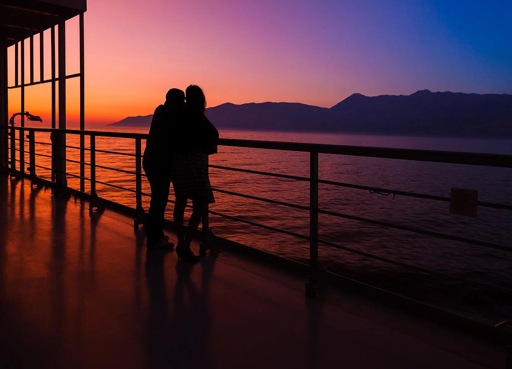 Couple enjoying sunset on Hawaii cruise from Honolulu