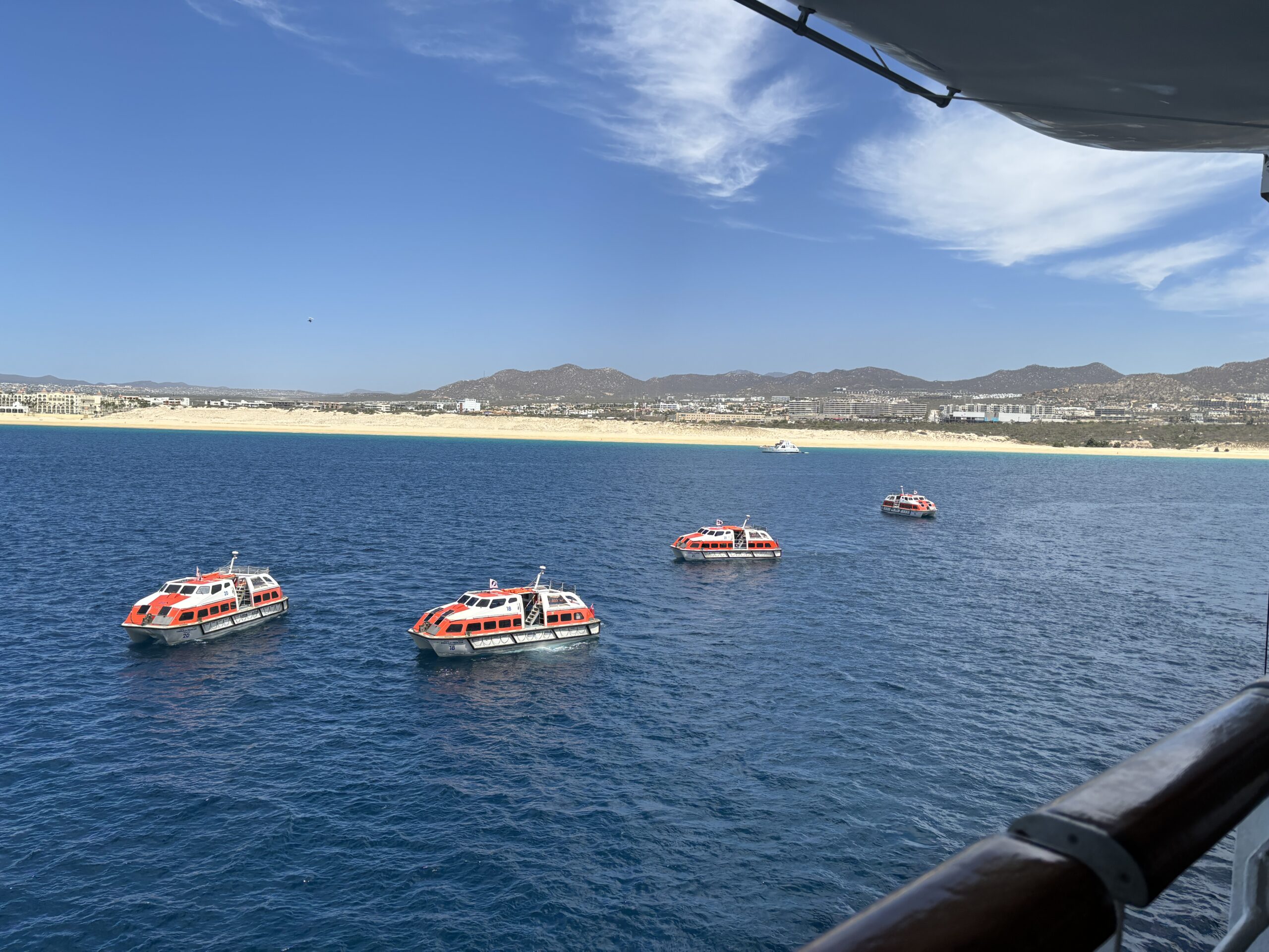 Cruise ship tender boats ferrying passengers ashore at Cabo San Lucas during a Panama Canal cruise