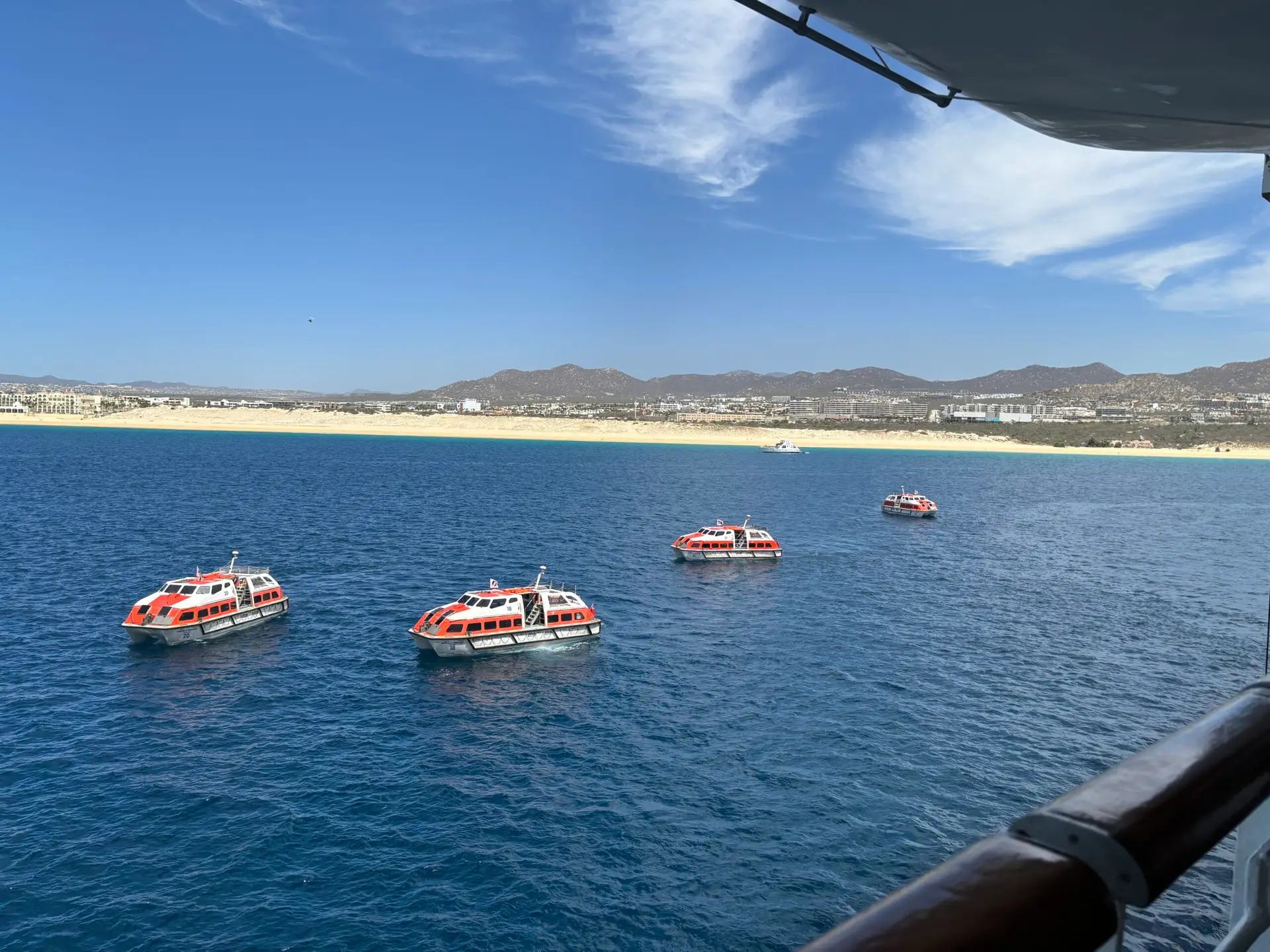Cruise ship tender boats ferrying passengers ashore at Cabo San Lucas during a Panama Canal cruise