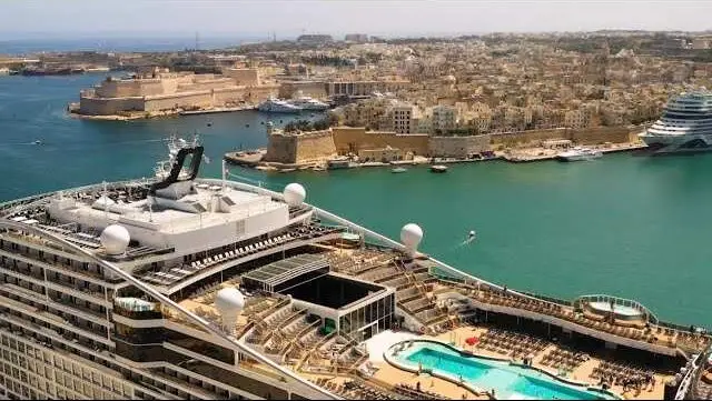 Cruise ship docked in Malta's Grand Harbour with Valletta's fortress walls behind